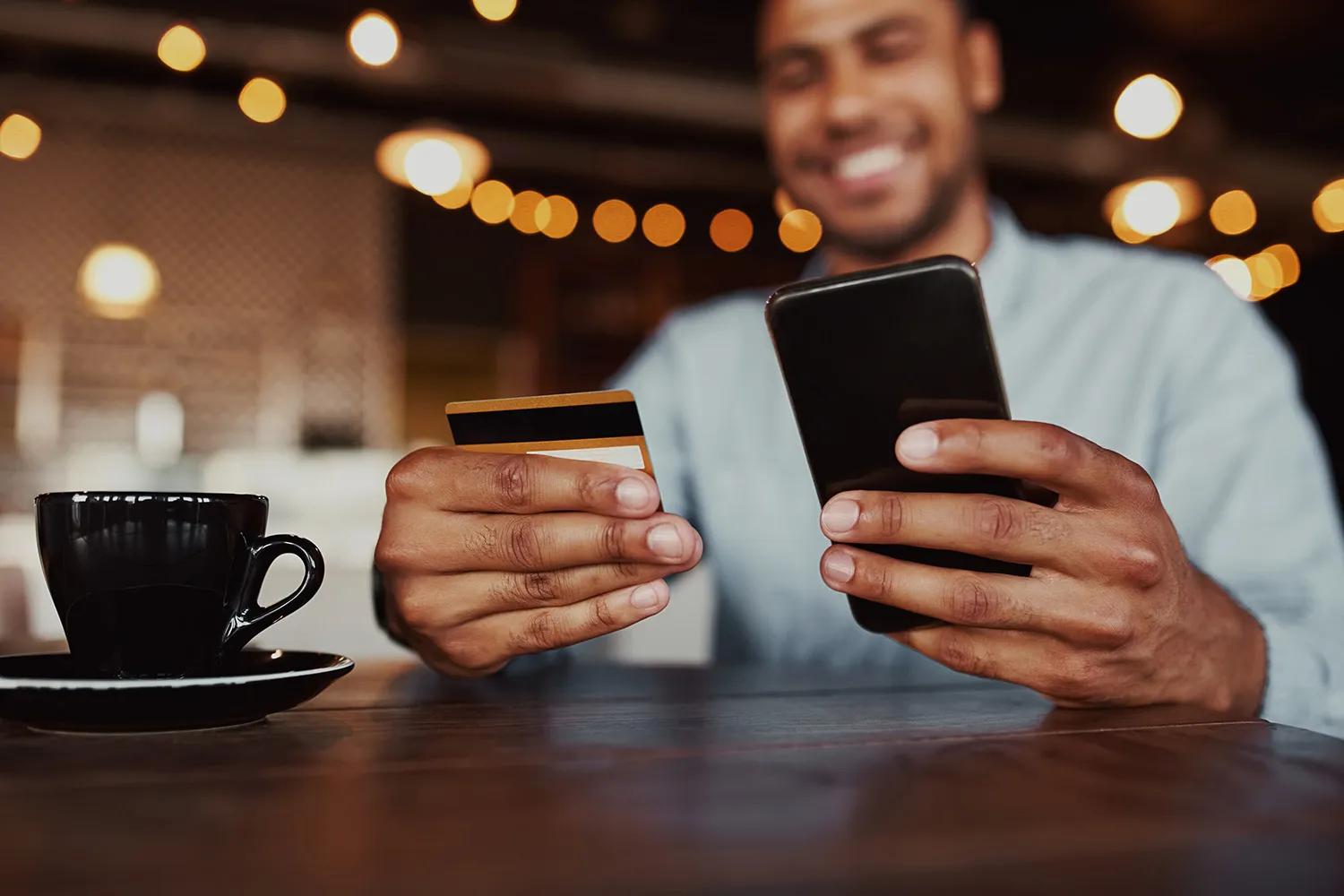 Man using credit card and phone