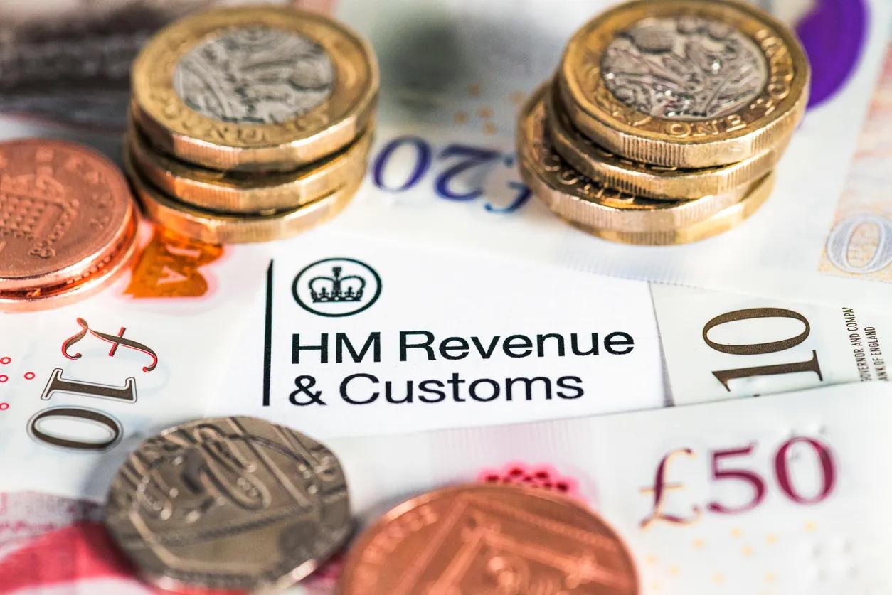 Pound coins on a HMRC tax bill