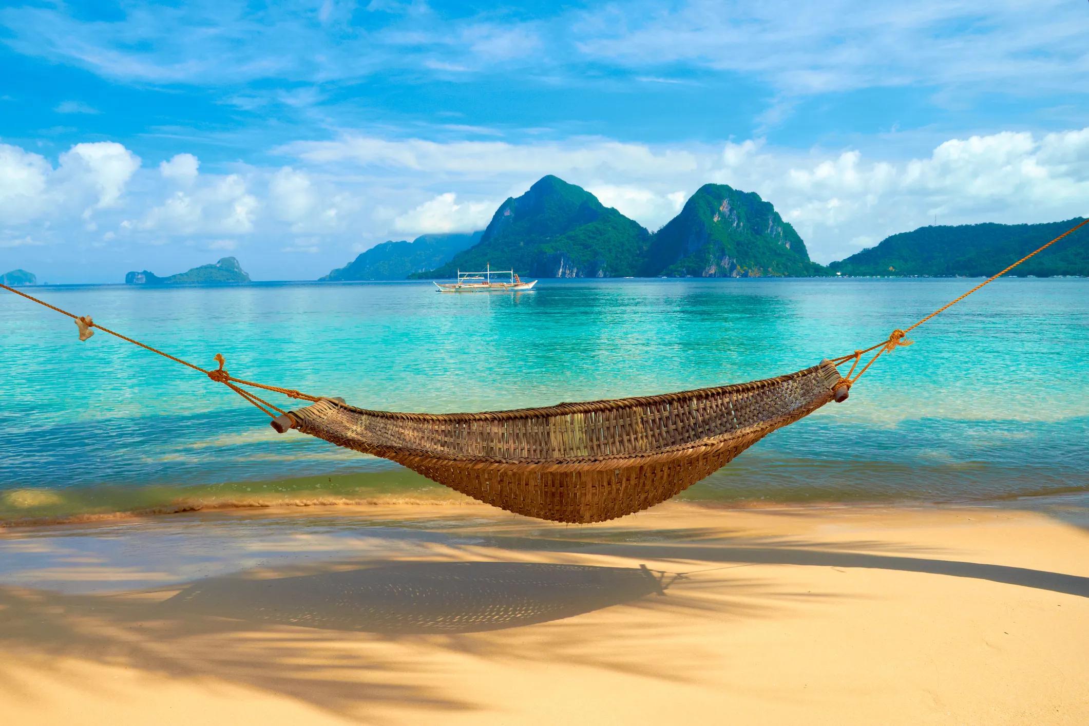 picture of empty hammock on beach by sea