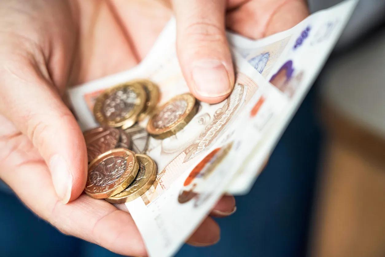 A saver holding cash